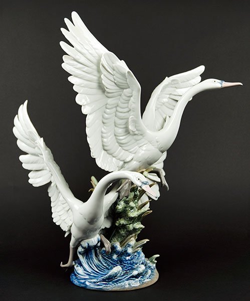 A Lladro Porcelain Figural Group 'Swans Take Flight'.: A Lladro Porcelain Figural Group 'Swans Take Flight'. Issue year 1992. Stamped with maker's mark, numbered VPT 34, and dated 1991 on underside 24" x 19" x 21"