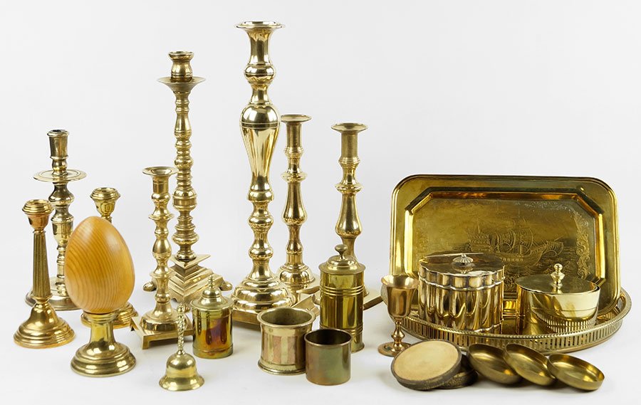A Collection Of Brass Decorative Articles.: A Collection Of Brass Decorative Articles. Comprising eight candlesticks, one wooden egg on brass stand, two trays, three cups, five lidded boxes, and one bell