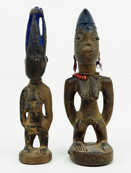 A Pair Of African Carved Wood Female Figures.: A Pair Of African Carved Wood Female Figures. One female figure bears handmade beaded necklaces Height: 12"