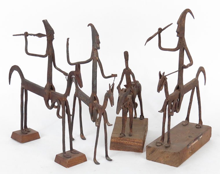A Collection of Metal Horse and Rider African: A Collection of Metal Horse and Rider African Sculptures. Four sculptures depicting a block horse and rider with spears Tallest: 14" X 12"