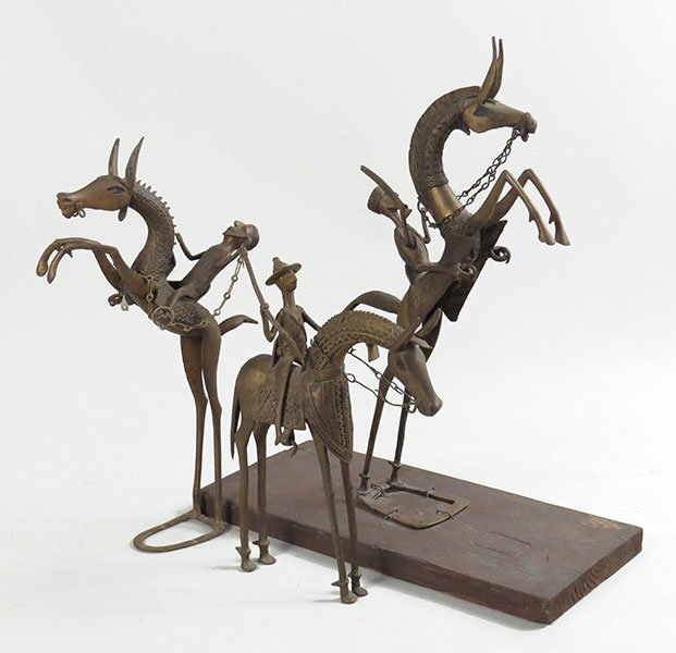 A Collection of African Benin Tribe Metal Sculputes.: A Collection of African Benin Tribe Metal Sculputes. A collection of three sculptures, two featuring a horse upright on hind legs with a man holding a sword. The third is a man on a horse holding a sp