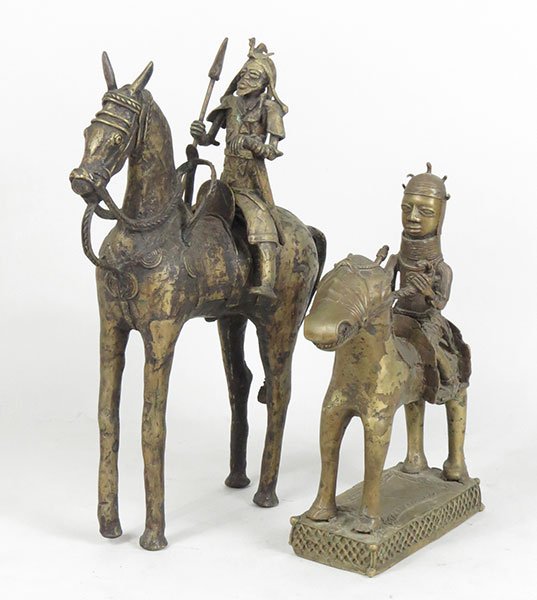 A Pair of Metal African Sculptures of a Man on a Horse.: A Pair of Metal African Sculptures of a Man on a Horse. Depicting figures carrying a sword and a spear Taller: 27" x 21" x 7.5"