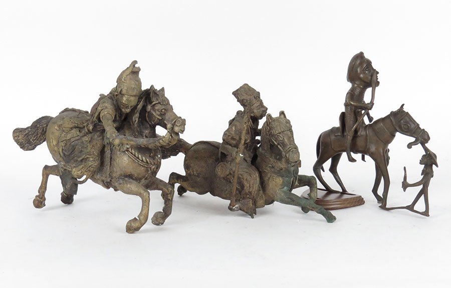 A Collection of African Sculptures of a Man on a Horse.: A Collection of African Sculptures of a Man on a Horse. Depicting two men on charging horses with swords and spears. Together with a man sitting on a horse with another man holding the bridle Tallest: