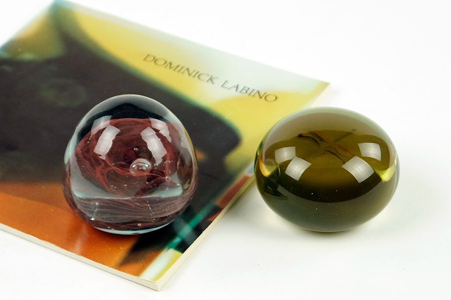 Two Dominick Labino Paperweights.: Two Dominick Labino Paperweights. Together with a small book about the artist. The smaller is signed and dated 1970 (2" x 2.75") and the larger is signed and dated 1966 (2.5" x 2.5")