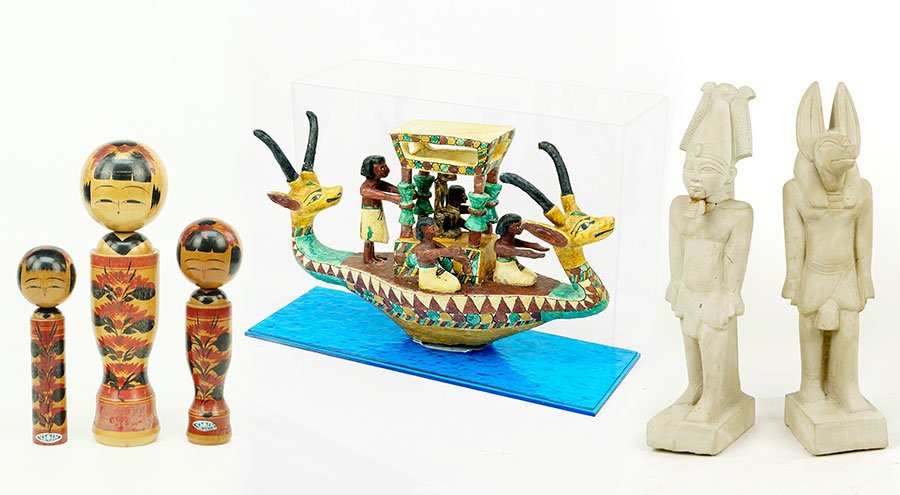 An Egyptian Model Ship.: An Egyptian Model Ship. Together with two Egyptian style figures and three kokeshi wood figures Display box: 12" x 20" x 7"