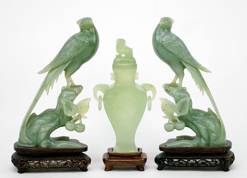 A Pair of Chinese Carved Quartz Phoenix.: A Pair of Chinese Carved Quartz Phoenix. Raised on 1.5" wood stands. Together with a carved green quartz urn. Lid of urn is formed by a sitting foo lion, while body bears free form round ring handles