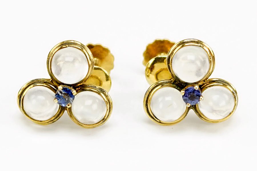 A Pair of Moonstone, Sapphire, and 14 Karat Yellow Gold: A Pair of Moonstone, Sapphire, and 14 Karat Yellow Gold Earrings. Containing three bezel set round cabochon moonstone with one prong set sapphire in the middle. Screwback fittings Wt: 3.2 grams