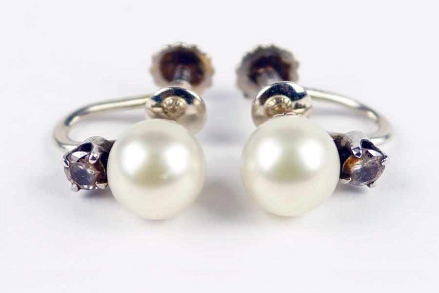 A Pair of Pearl, Diamond, and 14 Karat White Gold: A Pair of Pearl, Diamond, and 14 Karat White Gold Earrings. Screwback earrings each contain one cultured pearl and one prong set round diamond. Pearls are approximately 8.5mm