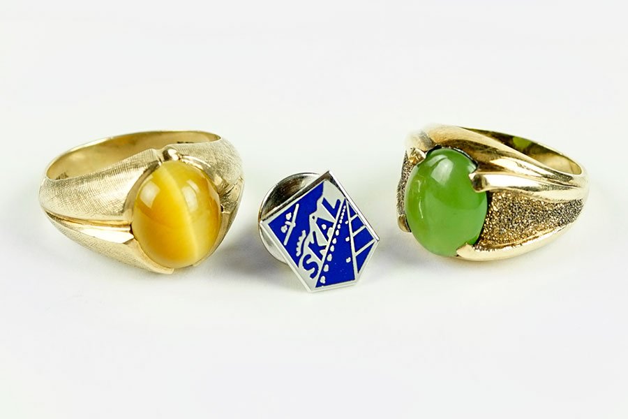 A 10 Karat Yellow Gold And Jade Ring.: A 10 Karat Yellow Gold And Jade Ring. Containing one cabochon jade stone. Together with a 10 karat yellow gold and cat eye ring and a sterling silver tie pin Jade Ring Size: 6