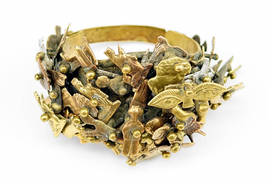 A Pal Kepenyes Mixed Metal Milagros Bracelet.: A Pal Kepenyes Mixed Metal Milagros Bracelet. Clasped cuff bracelet comprising layers of various attached folk figures. Signed on inside of cuff Length: 8"
