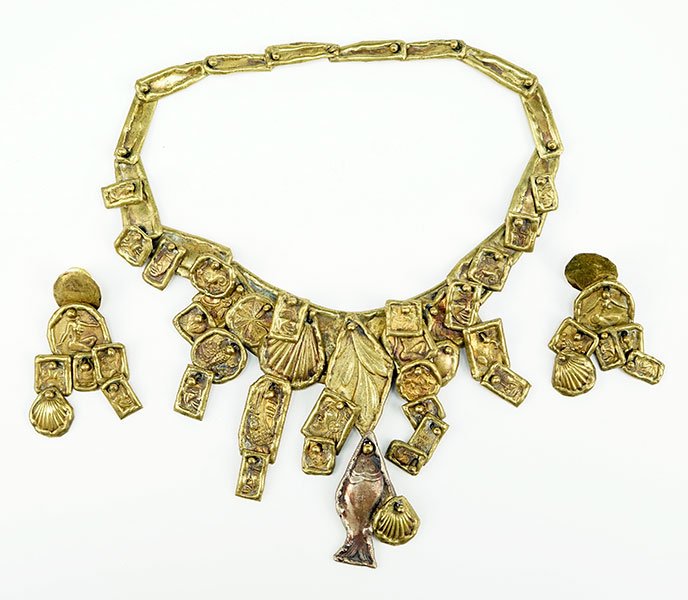 A Pal Kepenyes Brass Demi-Parure.: A Pal Kepenyes Brass Demi-Parure. Comprising a necklace and pair of earrings. Each piece contains articulated fish, shell, and human forms. Necklace is signed on reverse Necklace Length: 17" Widest Po