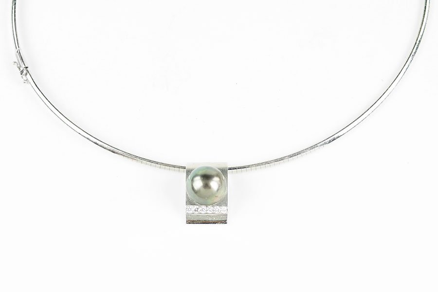 A Tahitian Pearl Pendant.: A Tahitian Pearl Pendant. 18 karat polished and brushed mounting contains one black Tahitian pearl which is approximately 13mm. Beneath the pearl are six round brilliant diamonds. Together with the pe