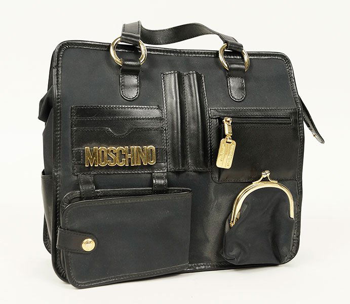 A Moschino By Redwall Black Nylon Handbag.: A Moschino By Redwall Black Nylon Handbag. Comprising leather handles and cross body strap. Bearing goltone plaque on back of bag reading 'Moschino Made in Italy by Redwall' 10.25" x 11.5"