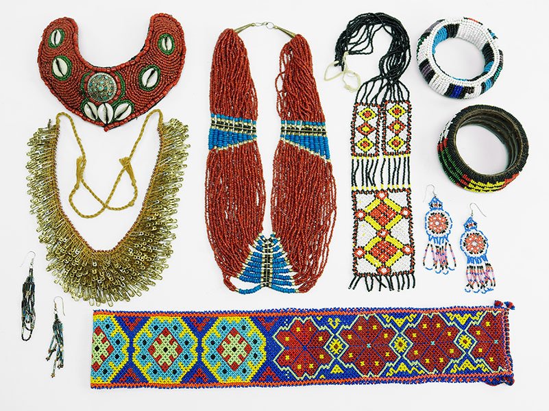 A Collection Of African Beaded Jewelry.: A Collection Of African Beaded Jewelry. Comprising four necklaces, two bangle bracelets, one pair of earrings, and one belt Belt Length: 36"