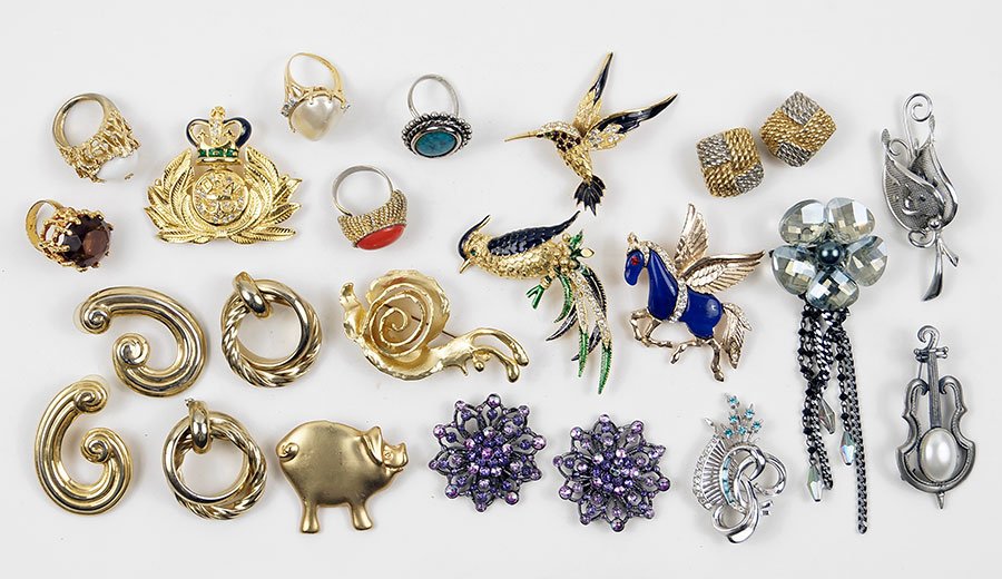 A Collection Of Costume Jewelry.: A Collection Of Costume Jewelry. Comprising brooches, ear clips, earrings, and rings. Signed pieces include those by Kenneth J Lane and Carolee