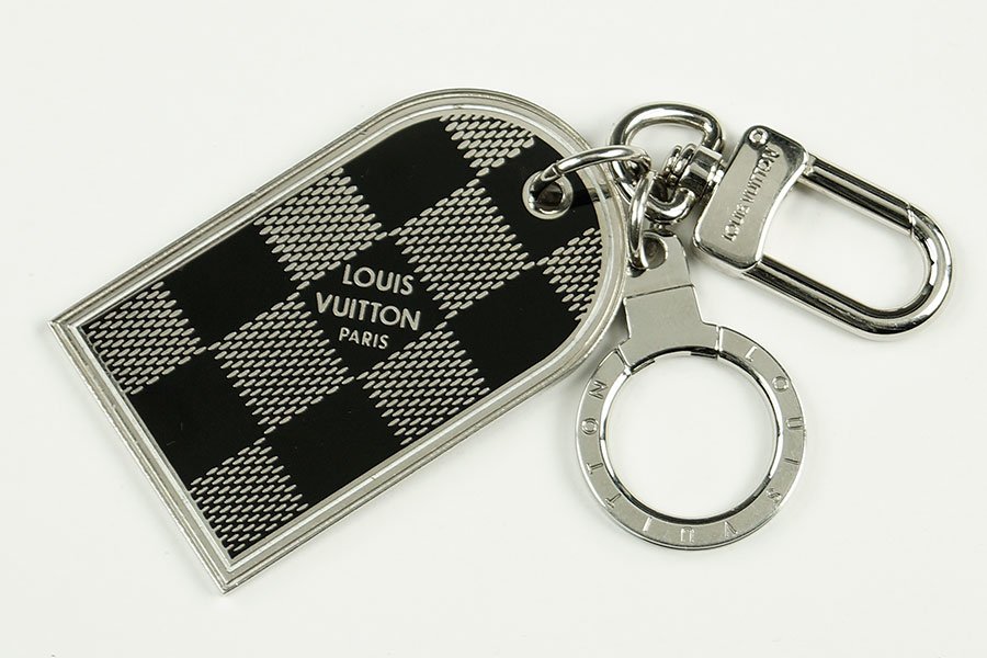 A Louis Vuitton Key Ring.: A Louis Vuitton Key Ring. Damier Collection, Palladium metal finish. With Vuitton pouch 2.75" x 1.5"