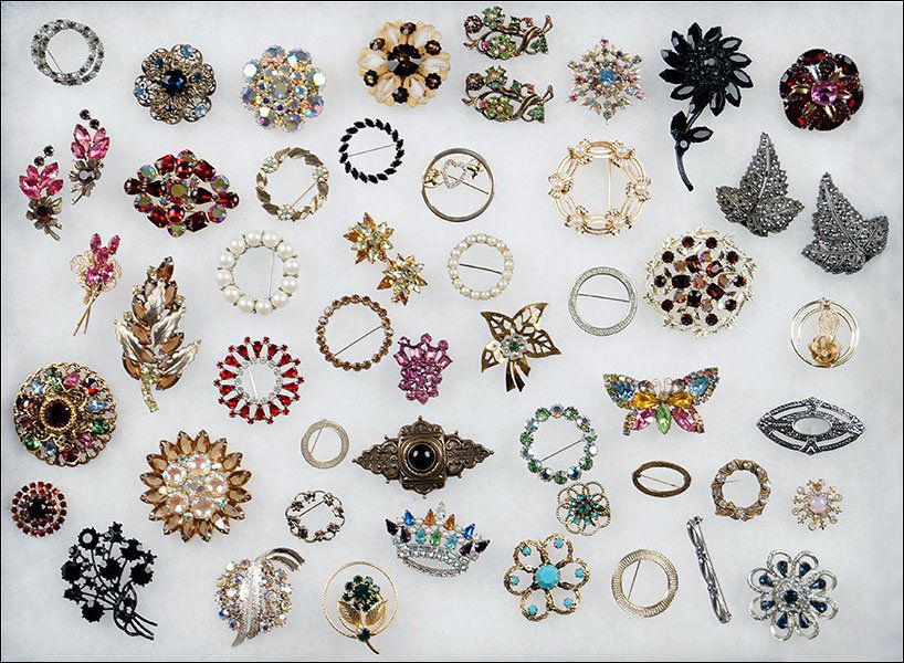 A Collection of Costume Jewelry.: A Collection of Costume Jewelry. Comprising 50+ brooches, including a Weiss mourning brooch, Trifari, as well a a pair of marcasite dress clips