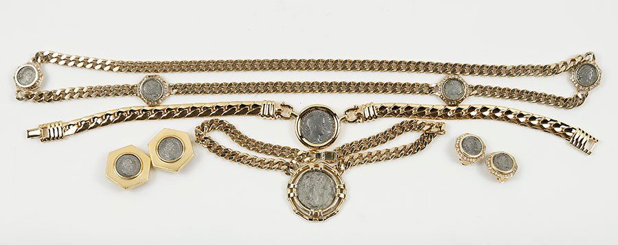 A Ciner Coin Form Demi-Parure.: A Ciner Coin Form Demi-Parure. Comprising a pair of earclips and a long link necklace. Together with a pair of Ben Amun coin form earclips, a Ciner single coin pendant necklace, and a Carolee coin pen