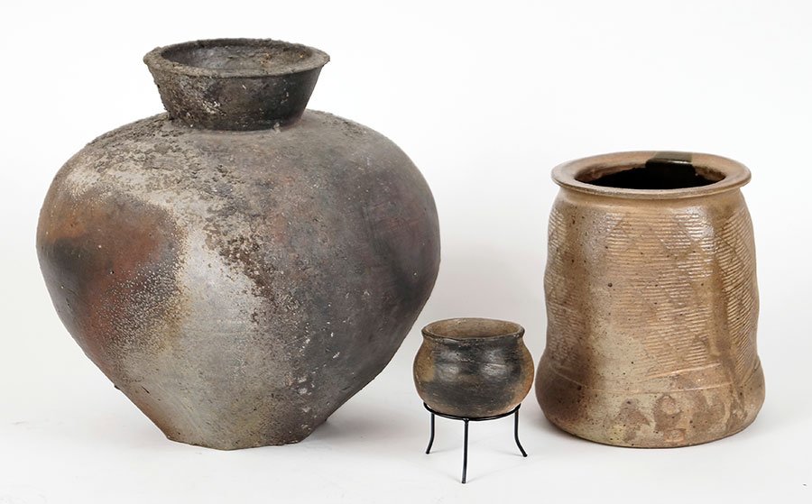 A Pre-Colombian Ceramic Urn.: A Pre-Colombian Ceramic Urn. Raised on metal stand. Together with an additional ceramic urn and a ceramic vase which is illegibly signed and dated '93 Pre-Colombian Urn: 2.5" x 3"