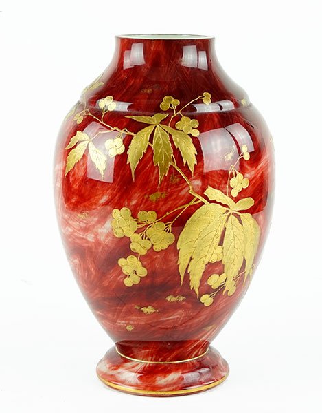 A Cased Glass Vase.: A Cased Glass Vase. Red marbleized glass vase with gold enamel decoration throughout depicting a bird amongst leaves and berries. In the style of Loetz 14.5" x 8.5"