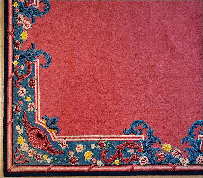 An Edward Fields Carpet.: An Edward Fields Carpet. Fuschia ground with a blue and floral border. Reverse is signed and dated 1987 11'4" x 9'4"