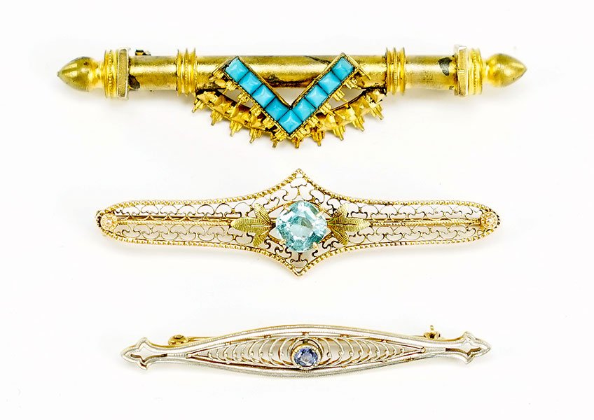A Victorian Turquoise And Gold Filled Bar Pin.: A Victorian Turquoise And Gold Filled Bar Pin. Containing nine turquoise beads. Together with a 14 karat yellow gold and sapphire bar pin and a 10 karat yellow gold and blue glass bead bar pin Length: