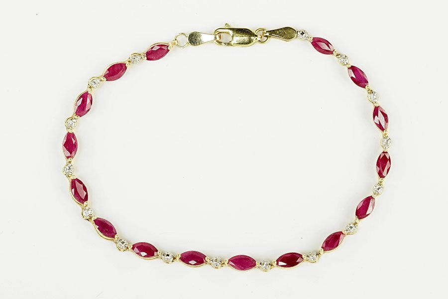 A Ruby, Diamond, And 10 Karat Yellow Gold Bracelet. (1 of 3)