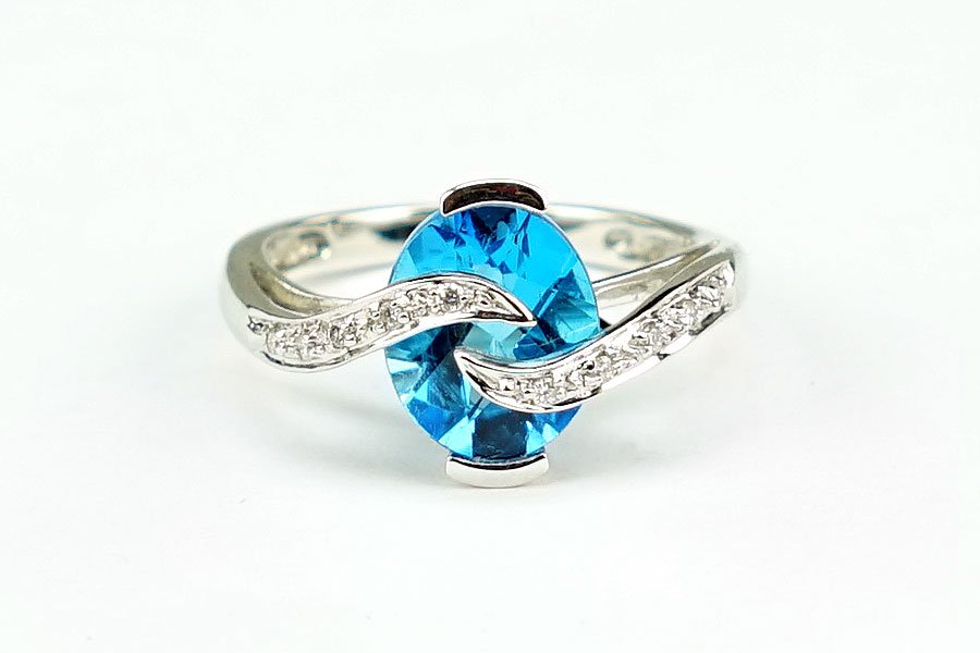 A Diamond, Blue Topaz, And 14 Karat White Gold Ring. (1 of 2)