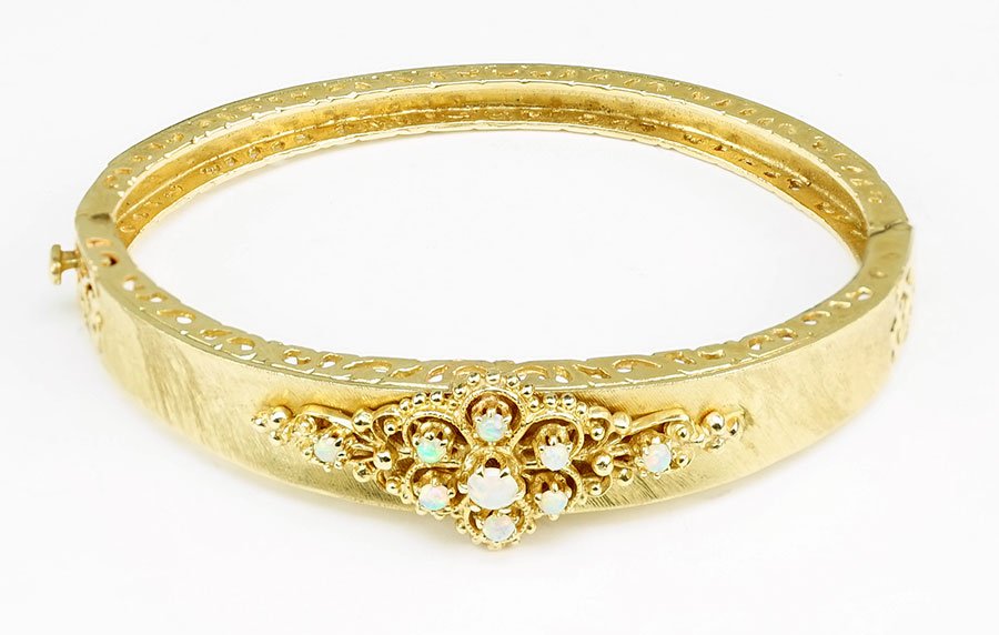 An Opal and 14 Karat Yellow Gold Bangle Bracelet. (1 of 1)