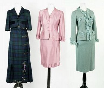 Two Moschino Skirt Suits.: Two Moschino Skirt Suits. Plaid wool skirt suit bears velvet buttons and pocket flaps on the jacket and leather buckles and beading around hem of skirt (Size 4). Blue wool skirt suit bears velvet and