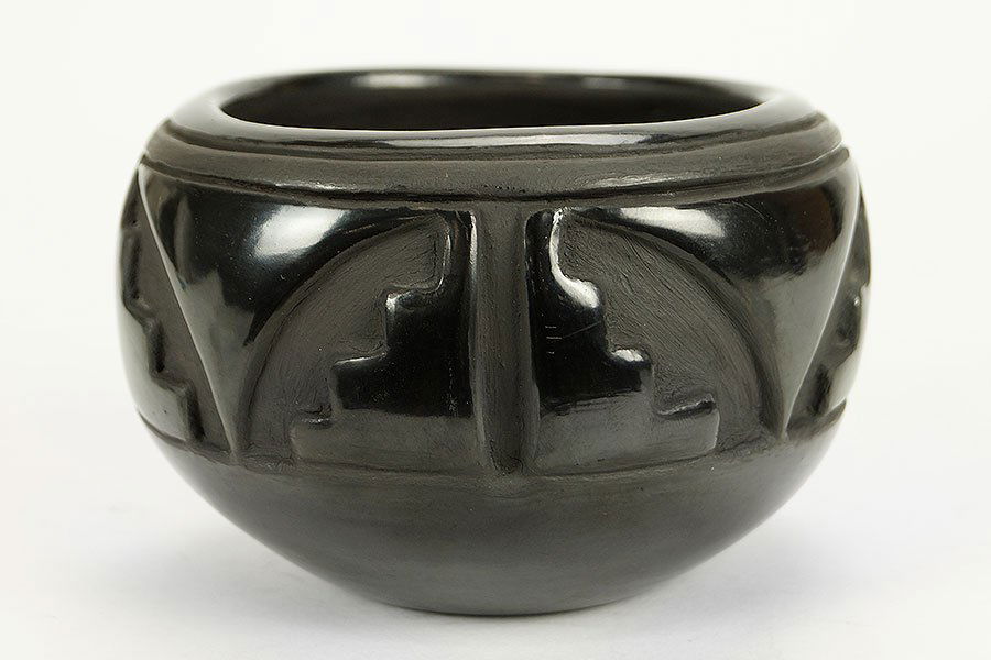 A Native American San Ildefonso Pottery Bowl by Helen: A Native American San Ildefonso Pottery Bowl by Helen Gutierrez. A carved black on black pottery bowl depicting stylized butterflies, signed on the underside Height: 3.5" Width: 5"