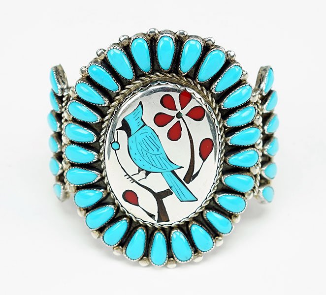 A Leo Harvey Turquoise, Coral, And Silver Cuff: A Leo Harvey Turquoise, Coral, And Silver Cuff Bracelet. Depicting a figure of a bluebird on a branch. Signed on reverse Length: 6.5"