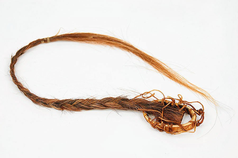 A Native American Lance/Spear Adornment.: A Native American Lance/Spear Adornment. Comprising braided horse hair and bone. Provenance: The Native American collection of Ralph Edward Guy Length: 19" Bone Oval: 2" x 2.5"