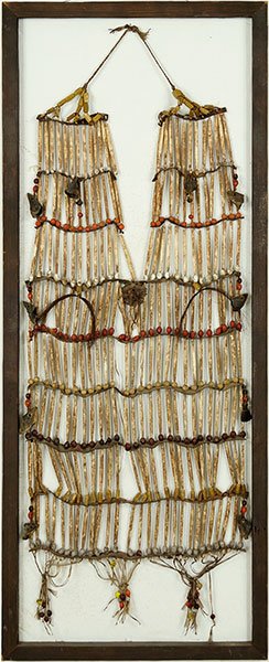 A 19th Century Native American Bone and Bead: A 19th Century Native American Bone and Bead Breastplate. A breastplate with over 200 bone hair pipes and various color glass beads, also decorated with pieces of hoof carved as a fish head, horse hai