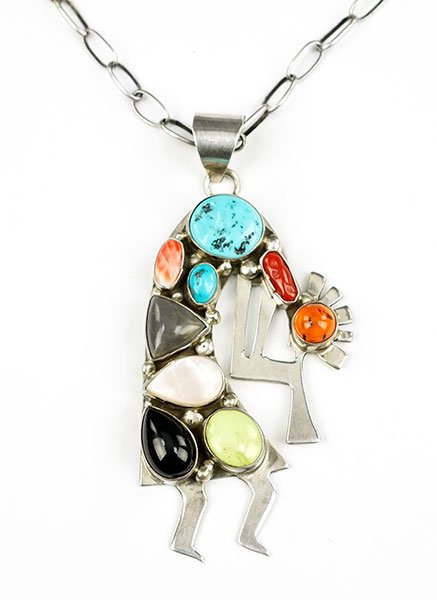 A Robert Kelley Sterling Silver and Semi-Precious Stone: A Robert Kelley Sterling Silver and Semi-Precious Stone Pendant. Pendant contains bezel set turquoise, amber, mother-of-pearl, onyx, coral and garnet. Together with a silver link chain Length: 22" Pen