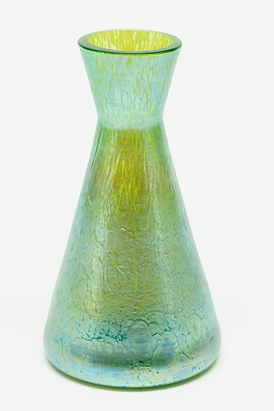 A Loetz Glass Vase.: A Loetz Glass Vase. Iridescent glass vase bears papillon style decoration on the tapered bottle form vase Height: 5.25"