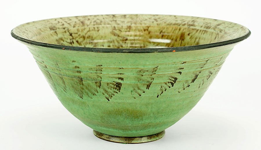A Glzed Terra Cotta Bowl.: A Glzed Terra Cotta Bowl. Hand thrown bowl with brown sponge decoration over green. Underside bears illegible incised marking 5" x 11"