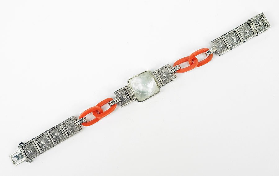 A Rock Crystal And Sterling Silver Bracelet.: A Rock Crystal And Sterling Silver Bracelet. A central sugar loaf cabochon rock crystal bears an etched design on all four sides. Flanking either side of the rock crystal is one square filigree link w