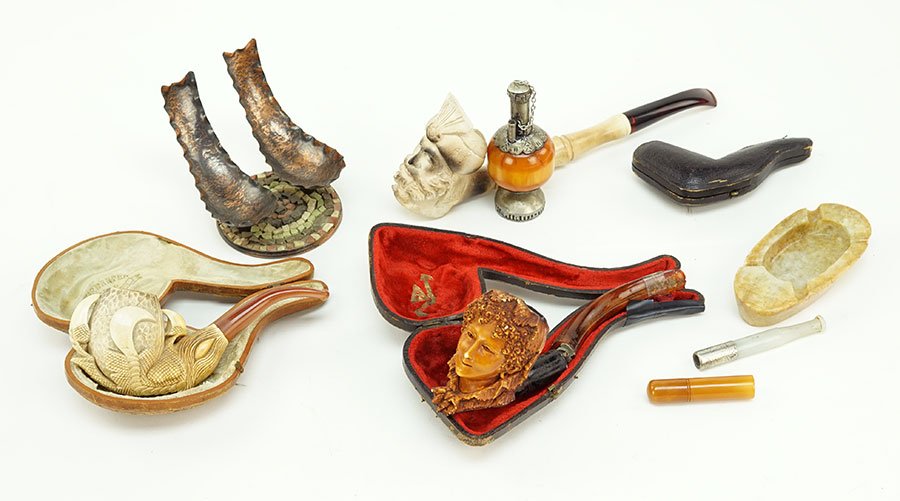 A Collection Of Tobacciana.: A Collection Of Tobacciana. Comprising a meerschaum pipe with fitted box, an additional meerschaum pipe, a pipe stand, two cases, and various decorative objects