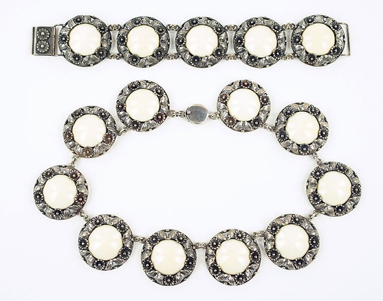 A Niels Erik From Bone And Sterling Silver Demi-Parure.: A Niels Erik From Bone And Sterling Silver Demi-Parure. Comprising a necklace and bracelet. Each cabochon bone is set within a silver flower pattern. Each piece is marked 'Sterling Denmark, N.E. From'