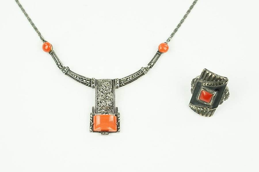 A German Art Deco Coral, Marcasite, And Sterling Silver: A German Art Deco Coral, Marcasite, And Sterling Silver Necklace. Necklace contains three cabochon coral pieces, center of necklace bears two flower forms. Together with an Art Deco coral, marcasite, 