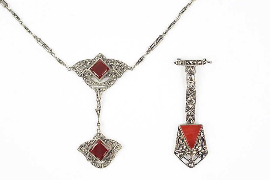 A German Carnelian, Marcasite, And Sterling Silver: A German Carnelian, Marcasite, And Sterling Silver Pendant Necklace. Pendant contains one square carnelian flanked by a marcasite and filigree sterling silver design, suspended from which is an additi