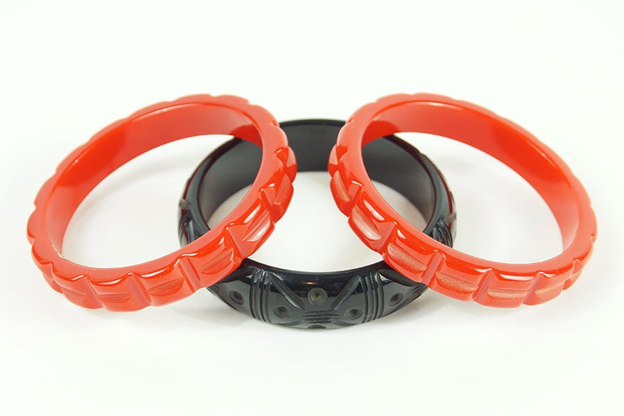 A Pair Of Red Carved Bakelite Bangle Bracelets. (1 of 1)