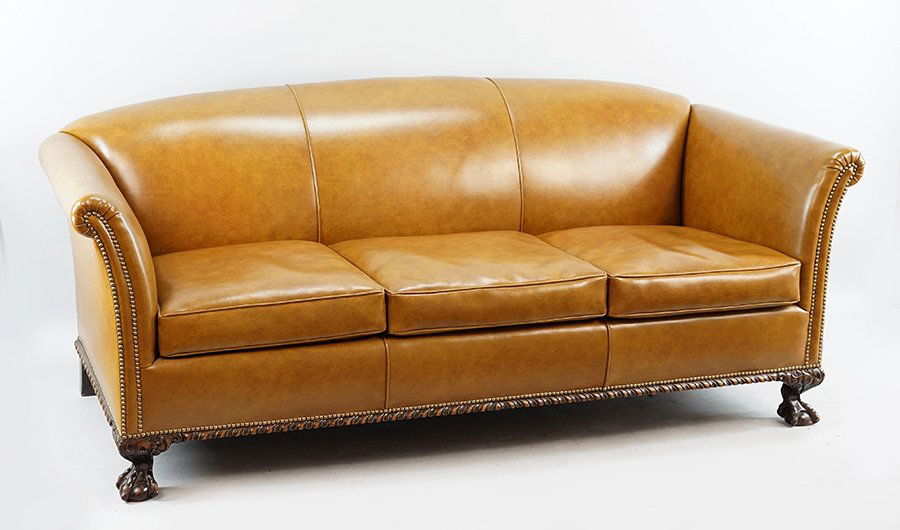 A Naugahyde Upholstered Three-Cushion Sofa. (1 of 1)