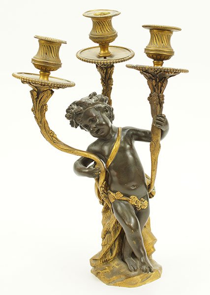 A French Patinated Metal Candelabrum.: A French Patinated Metal Candelabrum. Depicting a figure of a cherub. Provenance: The Estate Of Payson "Bunky" Cushing Height: 14"