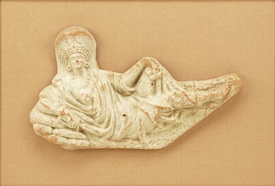 An Etruscan Style Terra Cotta Reclining Figure.: An Etruscan Style Terra Cotta Reclining Figure. Mounted to a frame Figure Length: 14" Frame: 16.25" x 21.75"