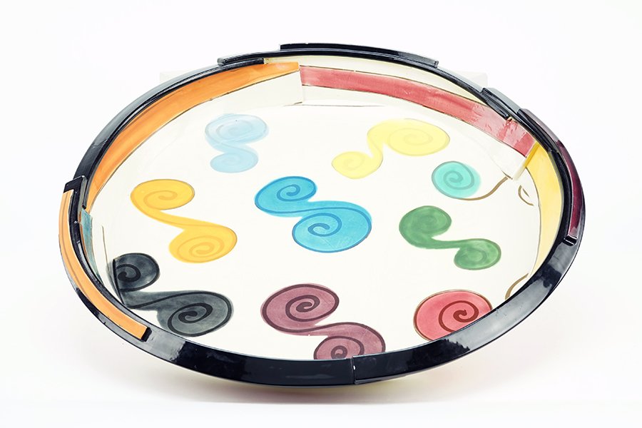 Judith Solomon (American, B. 1932) A Charger.: Judith Solomon (American, B. 1932) A Charger. Glazed ceramic charger in multi-colored decoration over a cream ground Diameter: 24"