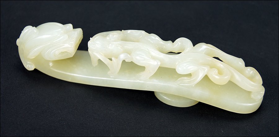 A Chinese Qing Period Carved Celadon Jade Belt Hook. (1 of 5)