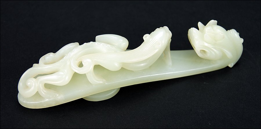 A Chinese Qing Period Carved Celadon Jade Belt Hook. (1 of 5)