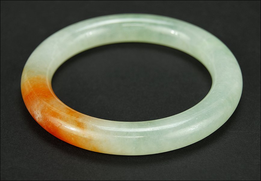 A Chinese Celadon and Russet Jade Bracelet. (1 of 4)